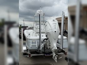 A sleek center console boat showcased from the back, featuring a powerful Yamaha engine and Garmin equipment, perfect for fishing or day cruising.