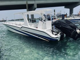 A sleek speedboat docked in clear waters, showcasing its modern design and powerful outboard motor — perfect for thrilling water adventures.
