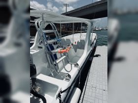 Interior view of a boat showcasing the seating and helm area, ideal for comfortable cruising and water adventures.