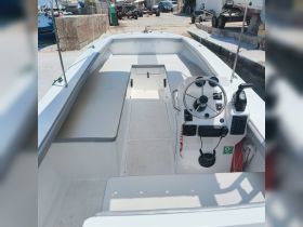 A clean and spacious interior view of a boat's helm and seating area, showcasing the layout and design ideal for comfortable cruising.