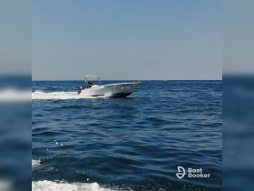 A speedboat navigates through the open waters, showcasing the thrill of boating adventures on a sunny day.