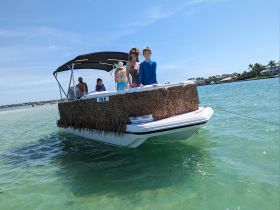 A family enjoys a sunny day on a boat, creating lasting memories in the clear waters — perfect for fun-filled outings and adventures.