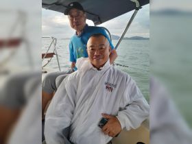 Two men enjoy a moment aboard a boat, showcasing the camaraderie and relaxation of a day on the water.