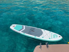 A paddleboard floats on crystal-clear waters, perfect for a day of fun and relaxation on the water. Ideal for those looking to enjoy water sports and leisure activities.