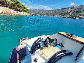 Snorkeling gear laid out on the deck of a boat, ready for an adventure in the crystal-clear waters — perfect for exploring underwater life.