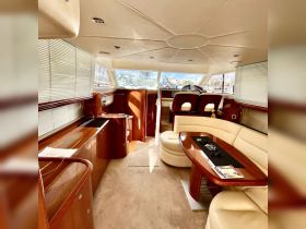 Interior view of a luxurious boat cabin featuring elegant seating and a well-equipped helm, perfect for comfortable cruising and relaxation on the water.
