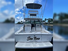 A clear view of the back of the 'Sea Time' boat, showcasing its structure and design, perfect for exploring the beautiful waters of the Cayman Islands.