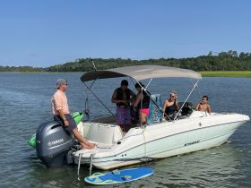 A lively group enjoys a day on the water aboard a Stingray boat, engaging in fun activities and creating lasting memories in the sun.