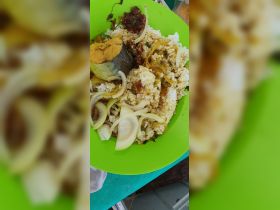 A delicious plate of rice and fish, showcasing local cuisine, perfect for enjoying onboard during a boating adventure.