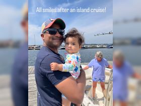 A joyful moment captured after an island cruise, featuring a father holding his child with smiles all around — a perfect family outing on the water.