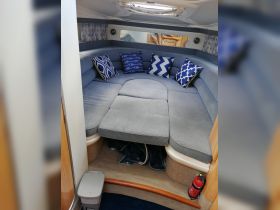 Cozy interior seating area of a boat featuring stylish blue and white cushions, perfect for relaxing during a day on the water.