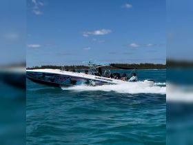 A lively group enjoys a thrilling ride on a speedboat, showcasing the excitement of water adventures in the Bahamas.