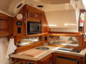 A well-equipped boat kitchen featuring modern amenities, perfect for preparing meals while at sea.