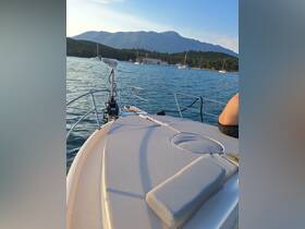 A serene view from the deck of a boat, showcasing the stunning mountains and calm waters, perfect for a relaxing day on the water.