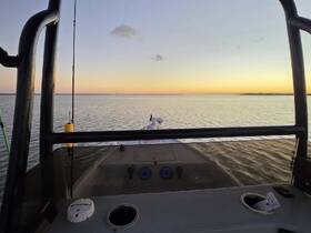 A serene view from the helm of a boat at sunset, showcasing the tranquil waters and the vessel's sleek profile.