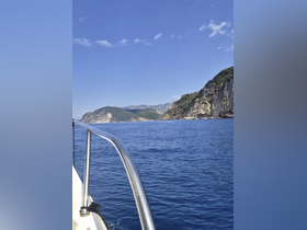 A picturesque view from a boat showcasing a stunning coastline and clear blue waters, perfect for capturing the essence of a relaxing day on the sea.