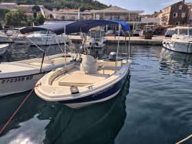 A sleek speedboat docked at a marina, showcasing its clean lines and inviting design — perfect for a day on the water.