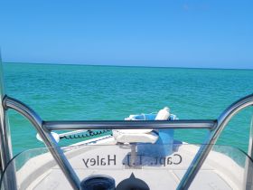 A clear view from the helm of a boat, showcasing the tranquil turquoise waters ahead — perfect for a day of exploration on the open sea.