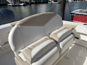 A close-up view of the comfortable seating area inside a boat, showcasing the stylish helm design — perfect for a day on the water.