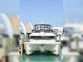 A stunning yacht docked at the marina, showcasing its elegant front profile against a clear blue sky — perfect for luxury charters and seaside adventures.