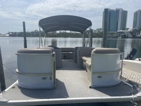 Interior view of a pontoon boat showcasing comfortable seating and lounge areas, perfect for relaxing on the water.