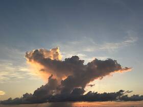 A captivating cloud formation at sunset, showcasing vibrant colors and intricate shapes in the sky.