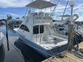 A sleek yacht docked at the marina, showcasing its elegant design and spacious layout, perfect for fishing or leisure trips.