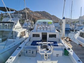 Interior view of a well-equipped boat cabin featuring seating and a helm, ideal for comfortable cruising and fishing adventures.