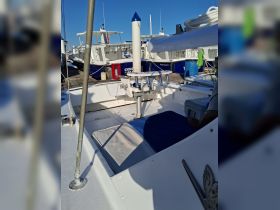Interior view of a boat's helm area featuring seating and equipment, ideal for a comfortable day on the water.