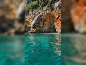 A stunning view of a rocky coastline with crystal-clear turquoise waters, perfect for exploring hidden coves and enjoying nature's beauty.