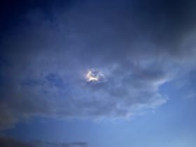 An unclear image of a cloudy sky with a hint of light peeking through, lacking identifiable subjects or details.
