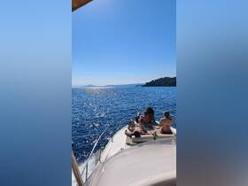 A group enjoys a relaxing day on the boat, sunbathing and taking in the stunning ocean views — perfect for summer adventures and island hopping.