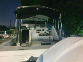 Interior view of a boat's helm area at night, showcasing the control console and seating arrangements, ideal for nighttime cruising.
