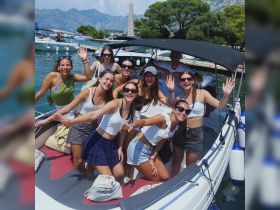 A lively group of friends celebrates on a boat, enjoying a sunny day on the water — perfect for summer outings and memorable adventures.