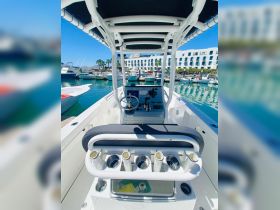 A well-equipped helm area of a boat featuring a sleek console and seating, perfect for navigating the waters in style.