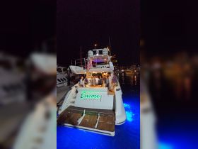 A lively group gathers on the deck of the 'Encore Las Vegas' yacht, celebrating under the night sky — perfect for unforgettable events and gatherings on the water.