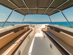 Interior view of a stylish boat cabin featuring comfortable seating, perfect for relaxing while enjoying a day on the water.