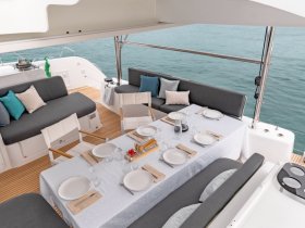 Elegant dining setup inside a boat, featuring comfortable seating and a beautifully arranged table, perfect for enjoying meals while cruising on the water.
