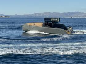 A sleek speedboat navigates through clear waters, showcasing its modern design and performance on the open sea.