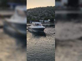 A serene view of a boat docked in calm waters, surrounded by lush greenery — perfect for a peaceful getaway.