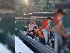 A cheerful group enjoys their time on a boat, showcasing a fun and relaxed atmosphere perfect for memorable outings on the water.
