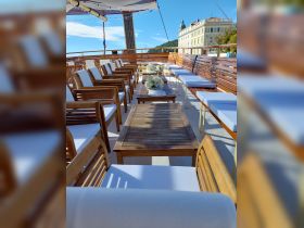 A beautifully arranged lounge area on a boat, featuring comfortable seating and elegant decor, perfect for relaxing during a cruise.