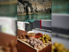 A beautifully arranged charcuterie board featuring a variety of snacks, perfect for enjoying on a boat trip. Ideal for catering and onboard dining experiences.