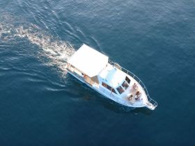 Aerial view of a lively group enjoying a boat ride, showcasing the fun and excitement of being on the water.