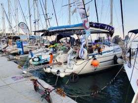 A beautifully docked yacht surrounded by other vessels, showcasing the vibrant marina atmosphere.
