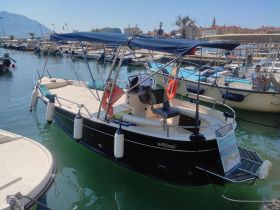 A sleek boat docked in a marina, showcasing its elegant design and features — perfect for leisurely outings on the water.