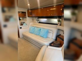 A cozy interior view of a boat's lounge area featuring comfortable seating and elegant decor, perfect for relaxing during a day on the water.