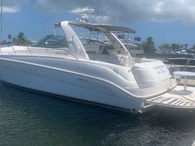 A sleek yacht named 'La Quiet' docked in calm waters, showcasing its elegant design and inviting atmosphere for luxury boating experiences.