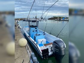 A well-equipped fishing boat docked at the marina, showcasing its sleek design and fishing gear — perfect for a day on the water.
