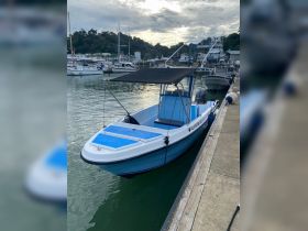 A well-maintained boat docked at the marina, showcasing its sleek design and vibrant colors — perfect for fishing or leisure outings.